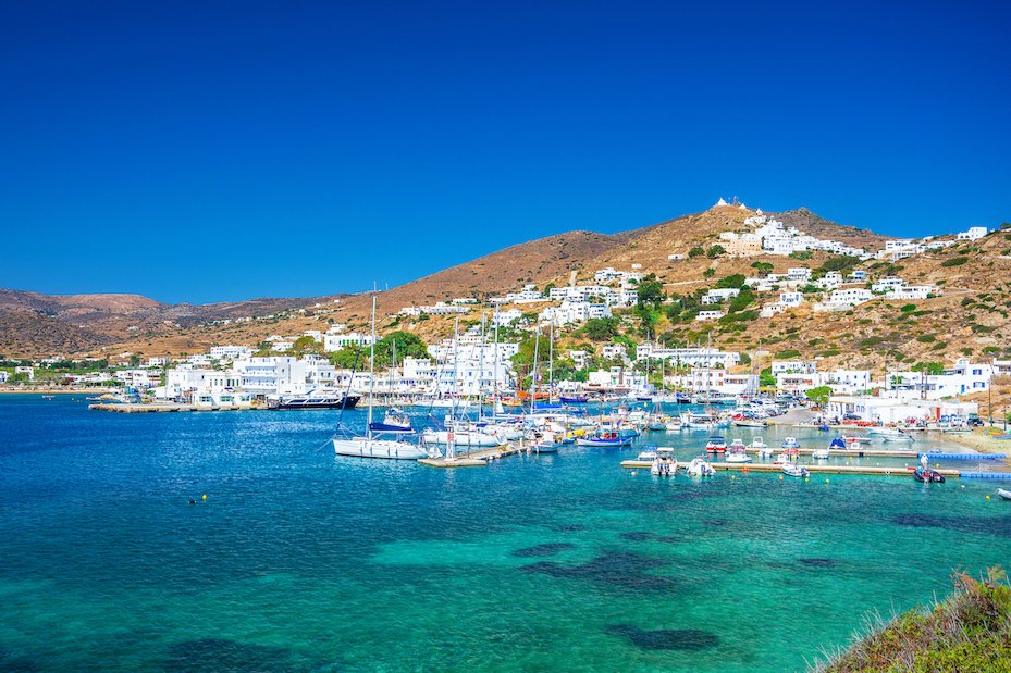 A gorgeous view of the harbour, mountains and clear turquoise water in Ios, Greece.